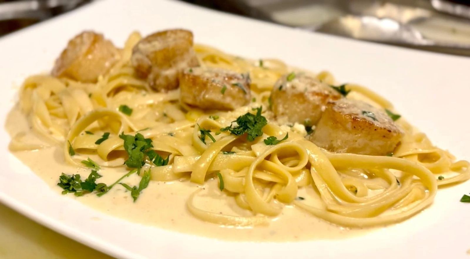 Sea scallops over fettuccine
